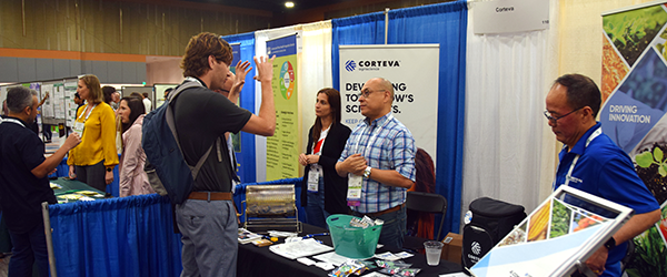 Plant Health attendee engaging with a Plant Health exhibitor. 